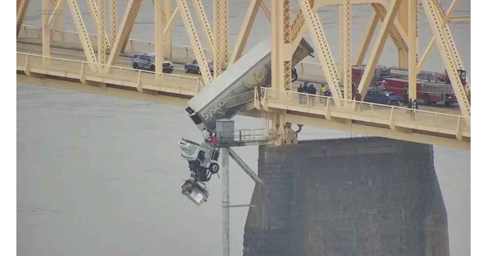 Truck driver safely rescued from dangling cab